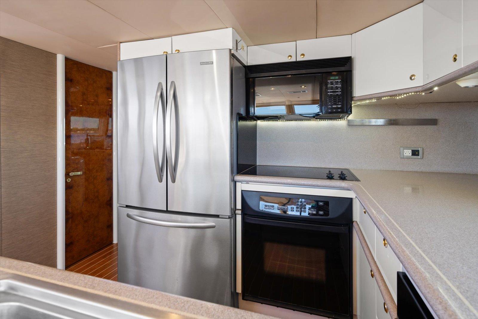Lazzara-EB 76 1997-Octopi FL-US-Modern kitchen in 1997 Lazzara EB 76 yacht with stainless steel appliances.-9736767 | Thumbnail