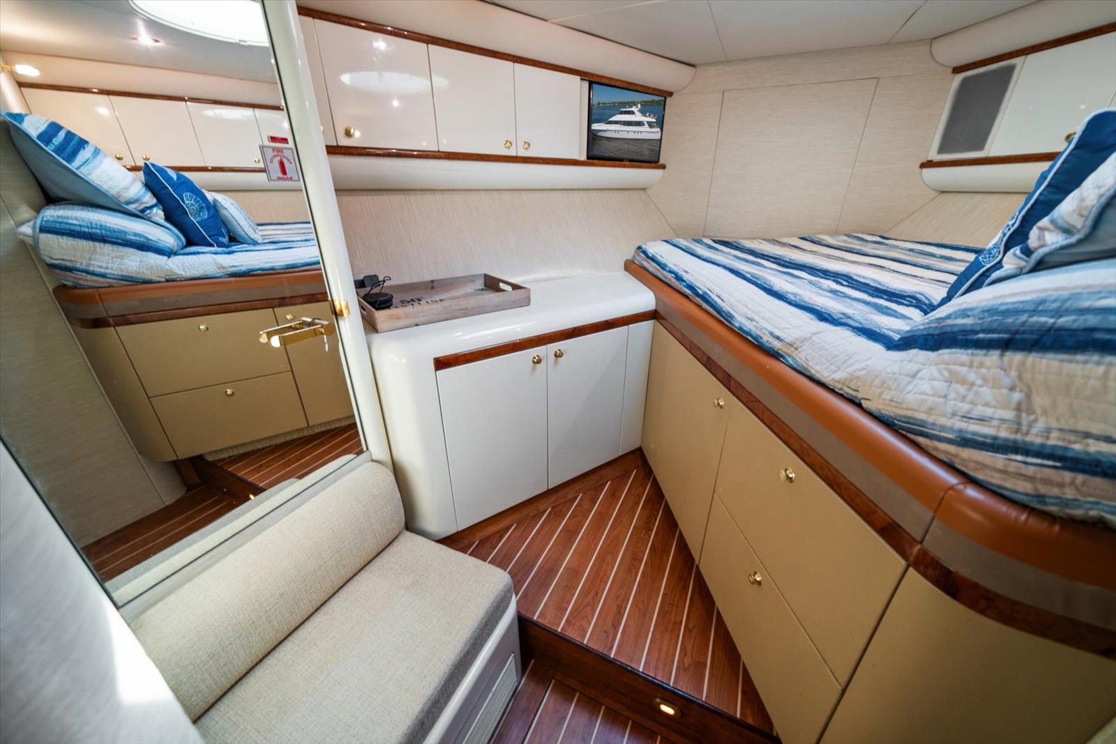 Lazzara-EB 76 1997-Octopi FL-US-Luxurious cabin interior of 1997 Lazzara EB 76 yacht with striped bedding and wood flooring.-9736767 | Thumbnail