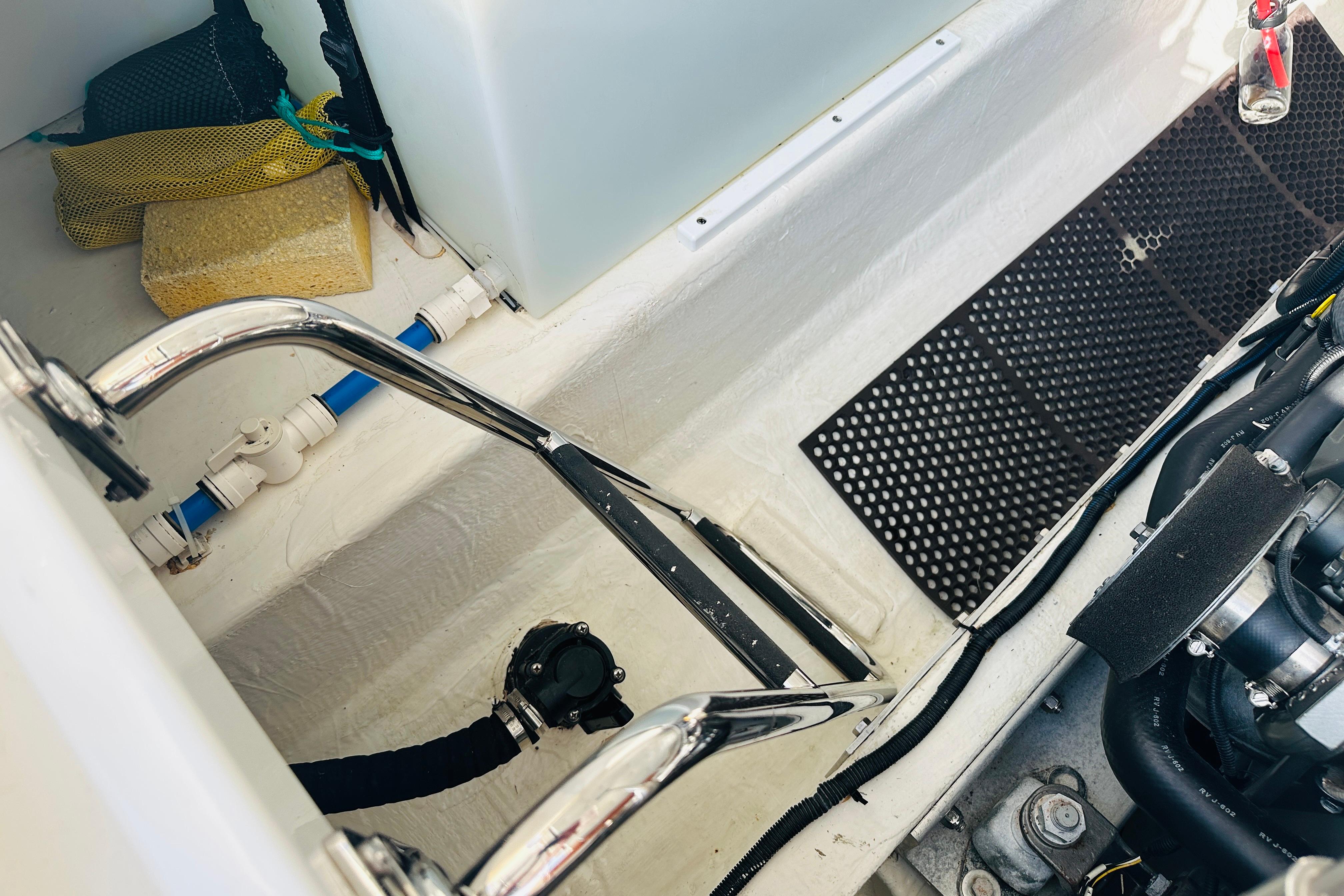 Engine compartment of a 2017 Back Cove 32 boat, showing pipes and equipment.