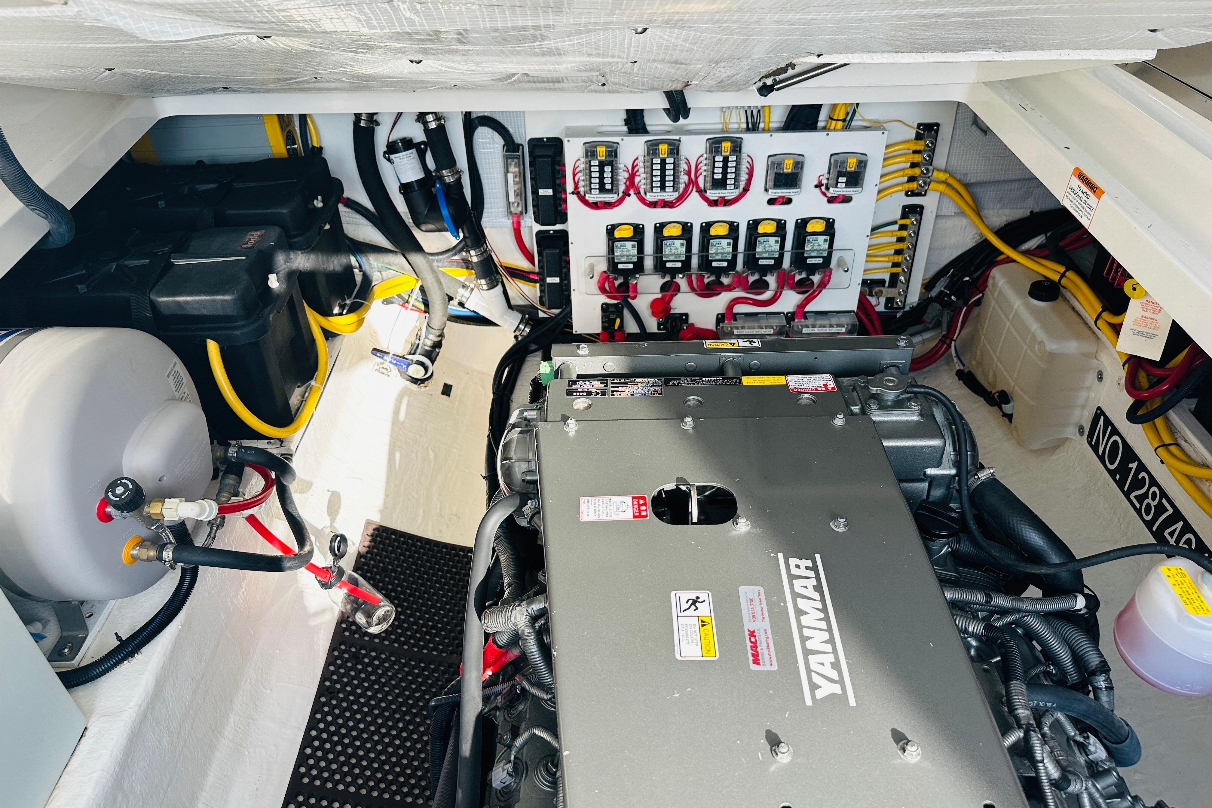 Engine room of 2017 Back Cove 32 boat with Yanmar engine and electrical panel.