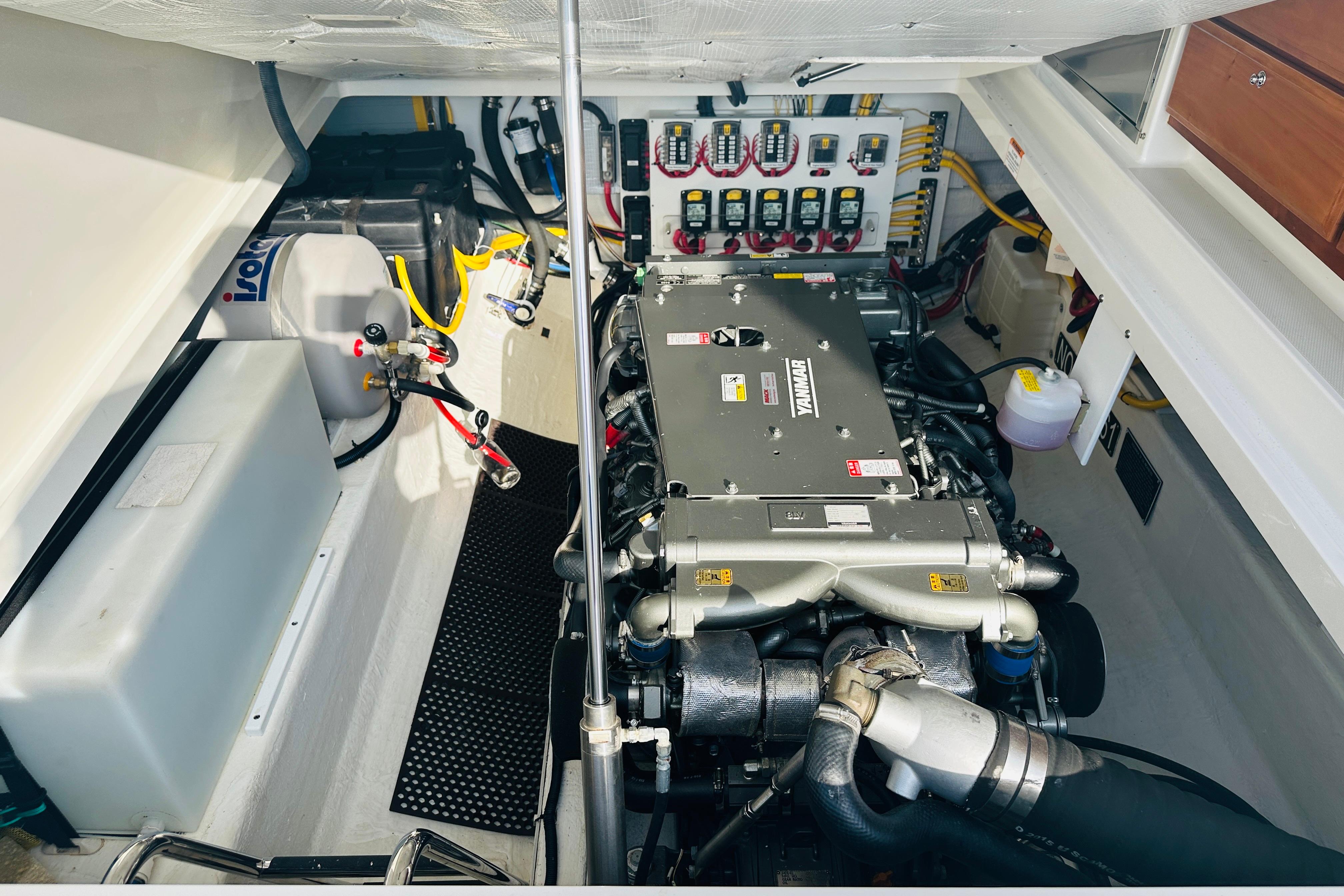 Engine room of 2017 Back Cove 32 boat, featuring a Yanmar engine and control panel.