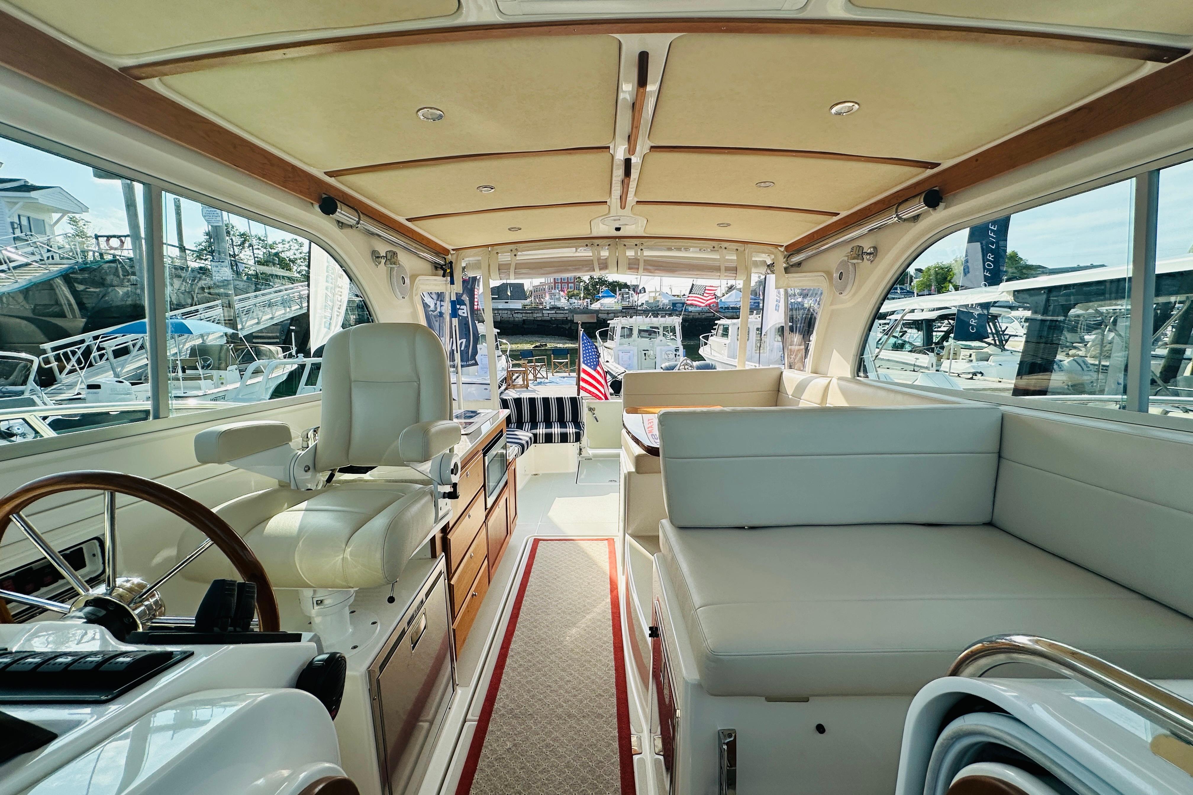 Interior of 2017 Back Cove 32 yacht with seating and helm station.