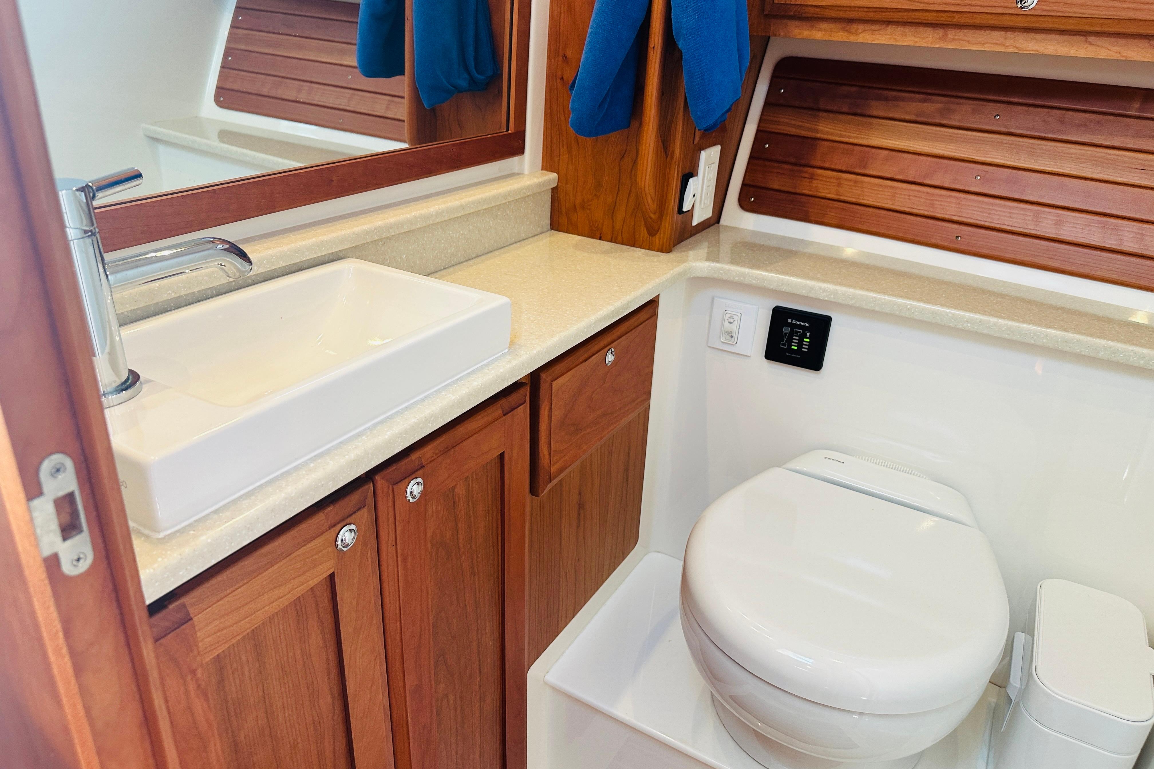 Luxurious bathroom in 2017 Back Cove 32 yacht with modern sink and toilet.