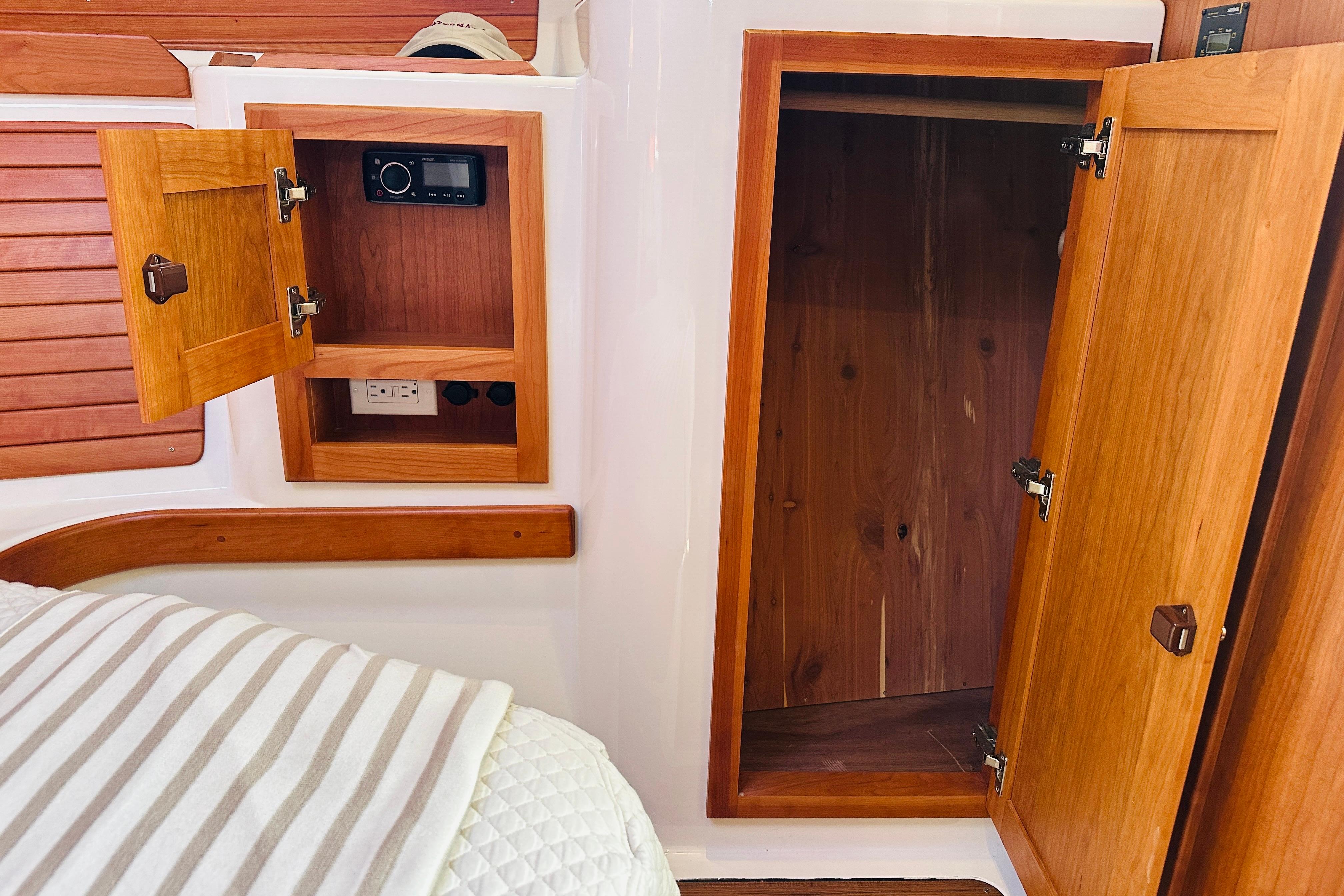 2017 Back Cove 32 interior with wooden cabinets and storage space.
