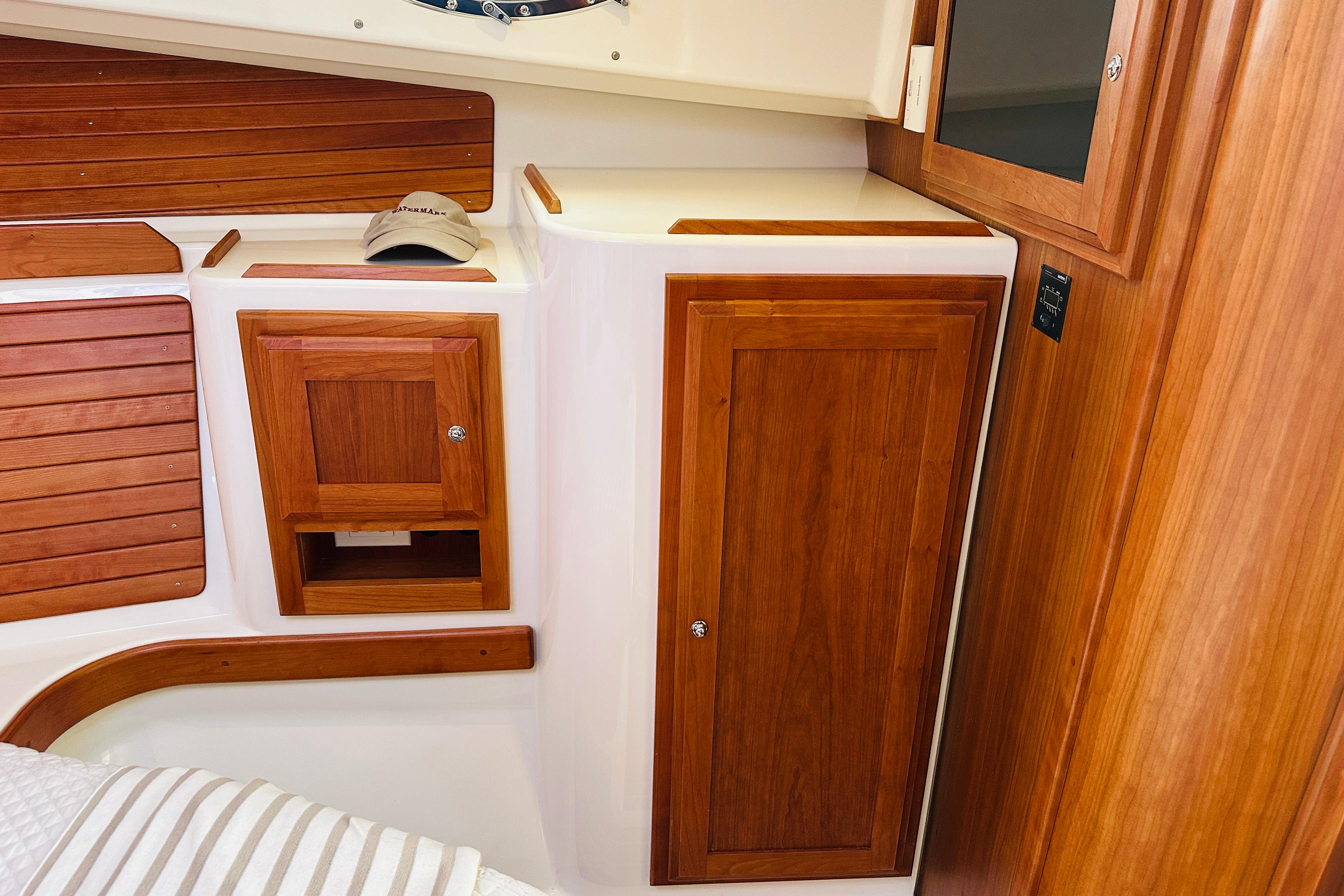 2017 Back Cove 32 interior with wooden cabinetry and storage compartments.