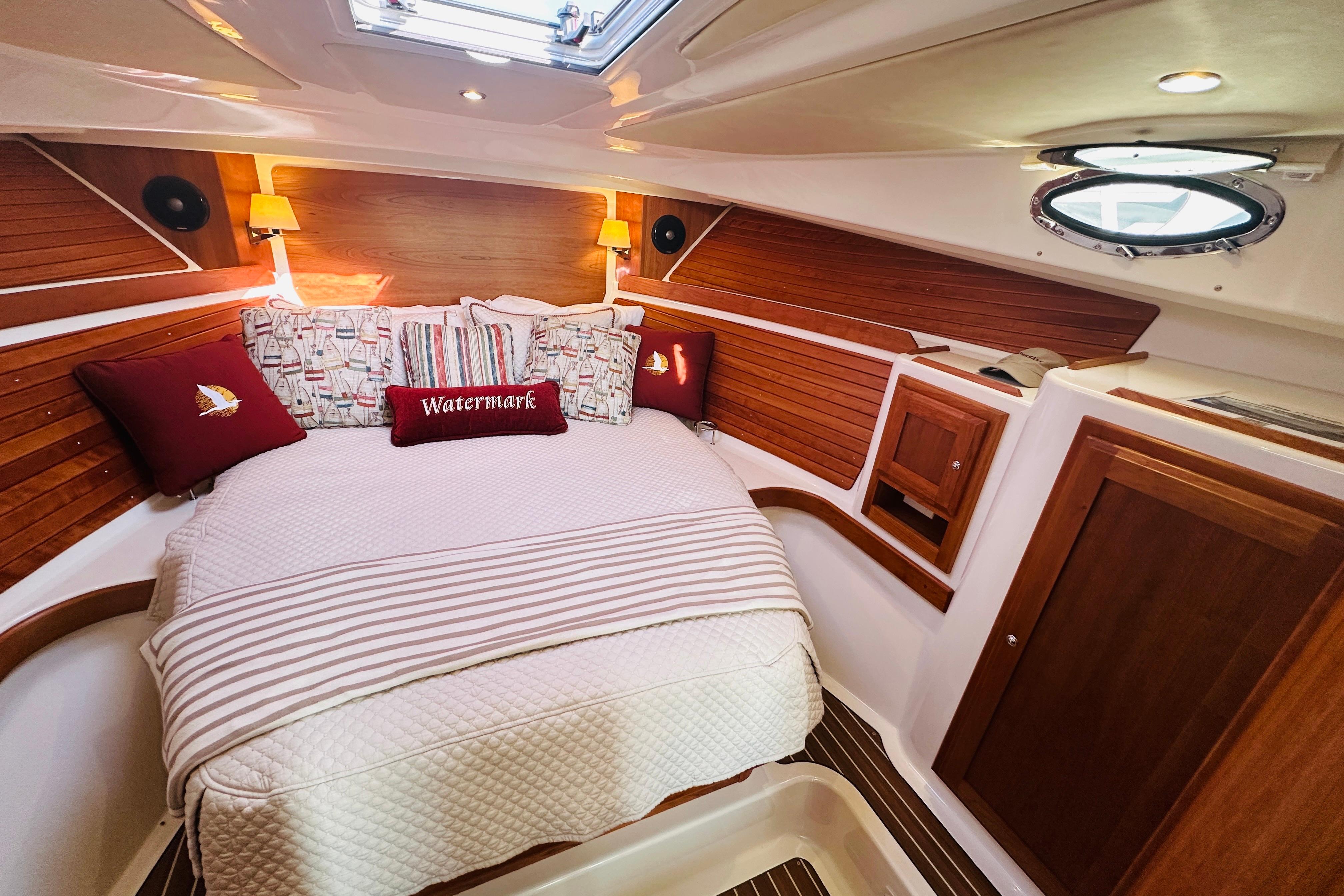 Cozy cabin interior of 2017 Back Cove 32 boat with wood accents and plush bedding.