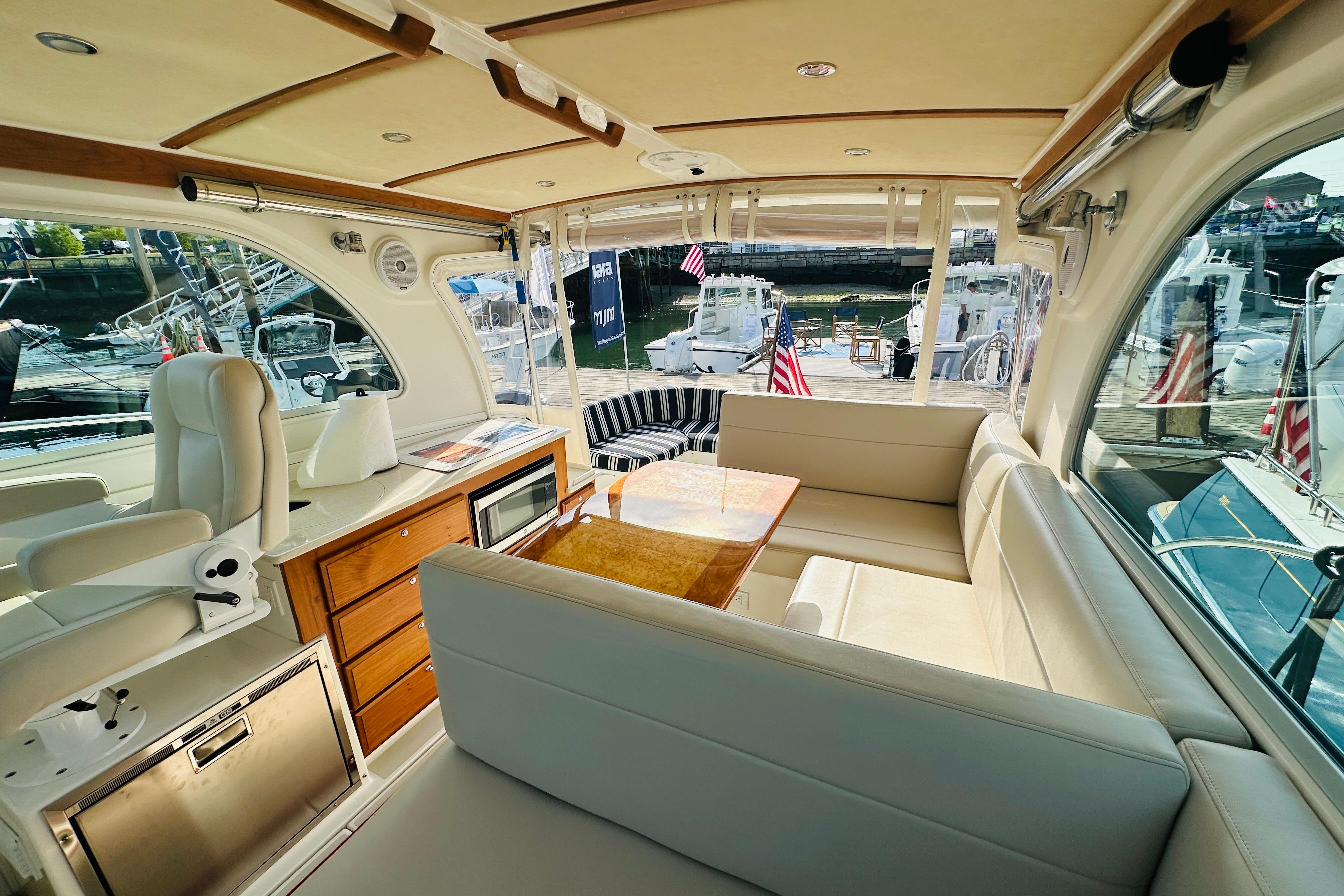 Luxurious interior of a 2017 Back Cove 32 yacht with seating and wooden accents.
