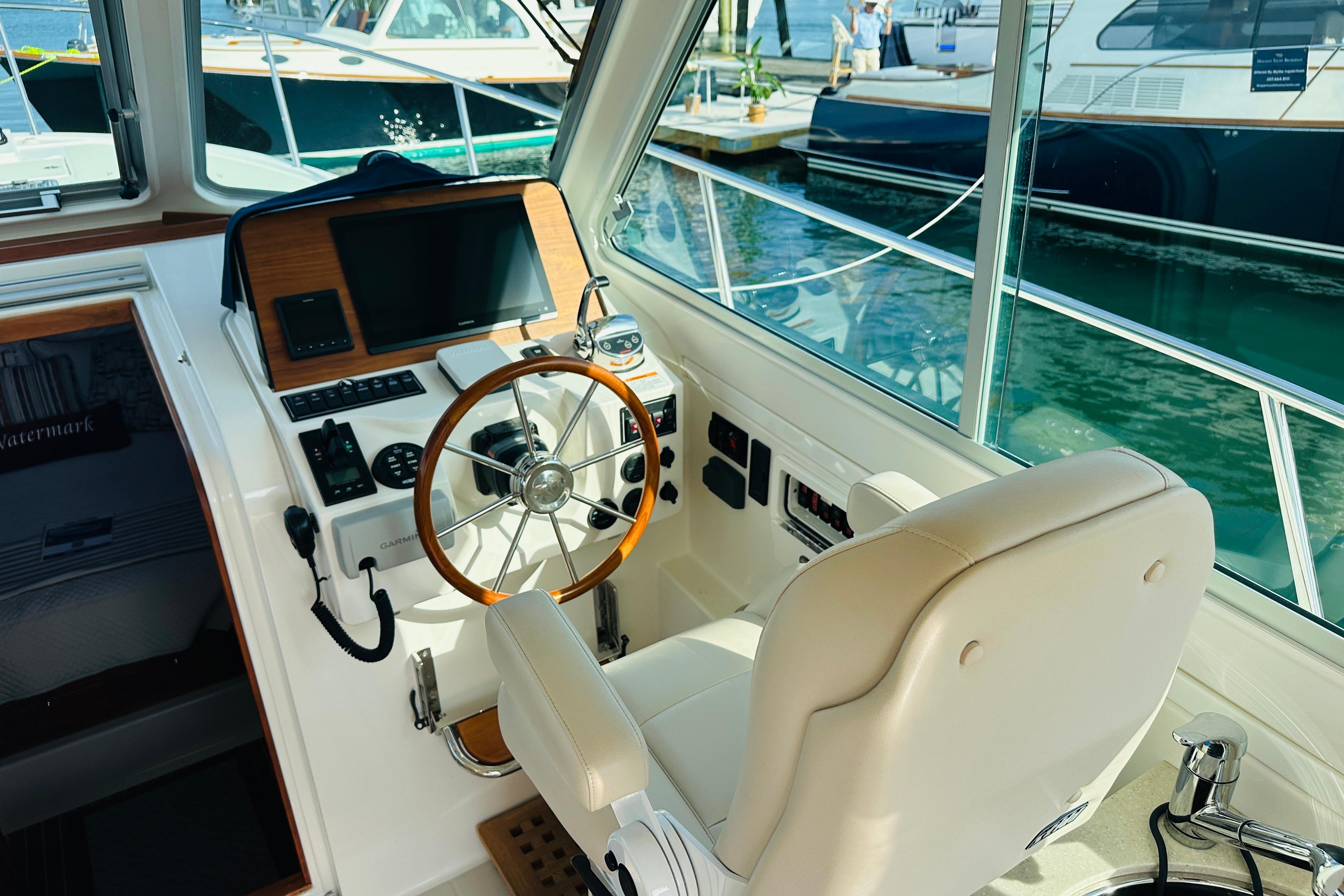 Interior helm of 2017 Back Cove 32 boat with steering wheel and navigation controls.