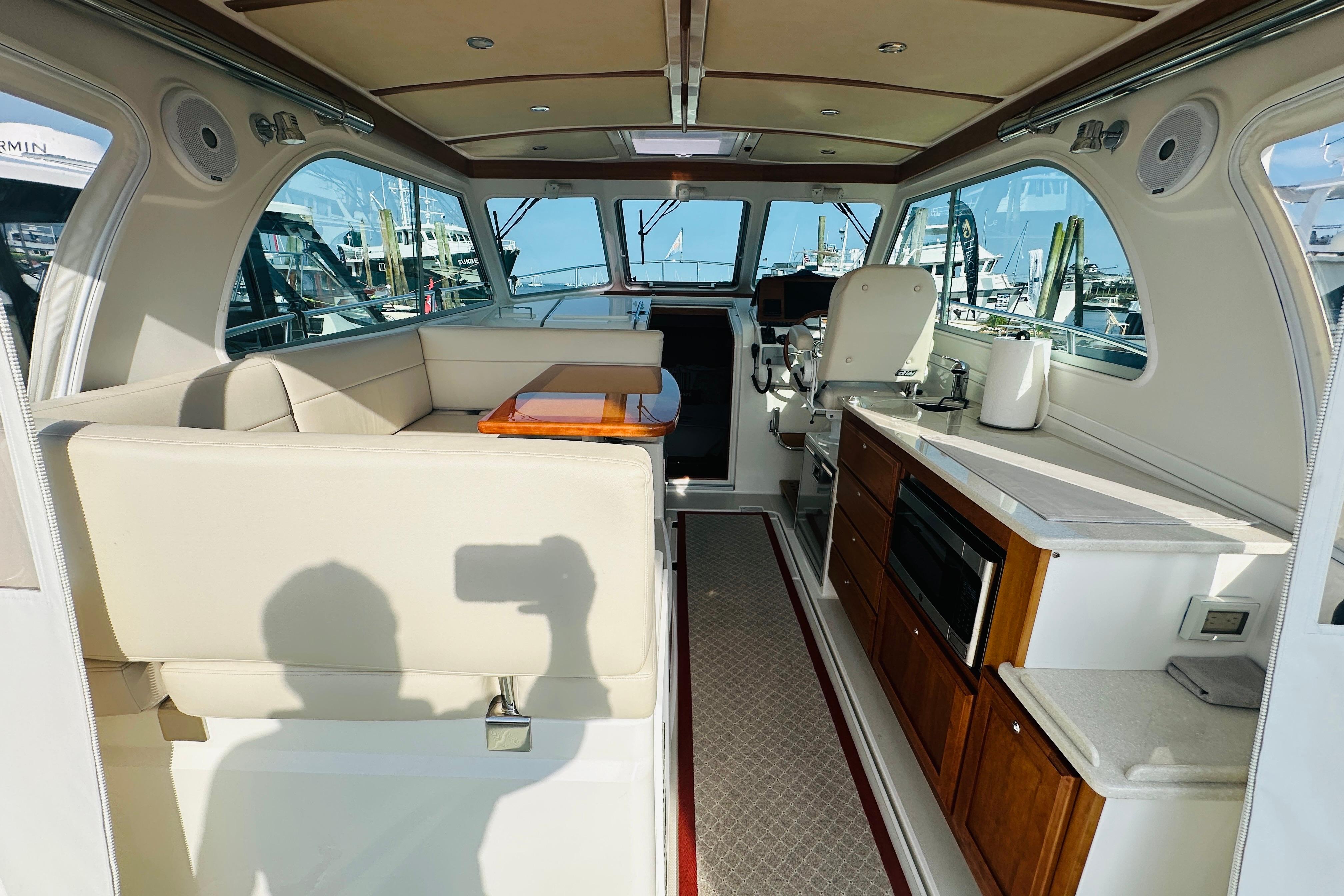 Interior of 2017 Back Cove 32 boat with seating, kitchenette, and helm station.