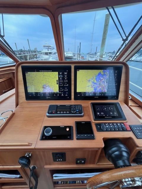 2021 Sabre 45 Salon Express helm with dual navigation screens and control panel.