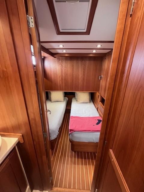2021 Sabre 45 Salon Express cabin with twin beds and wooden interior.