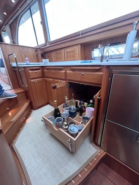 Luxurious 2021 Sabre 45 Salon Express yacht kitchen with pull-out beverage drawer.