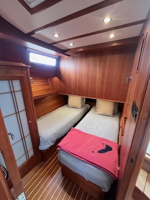 2021 Sabre 45 Salon Express cabin with twin beds, wooden interior, and soft lighting.