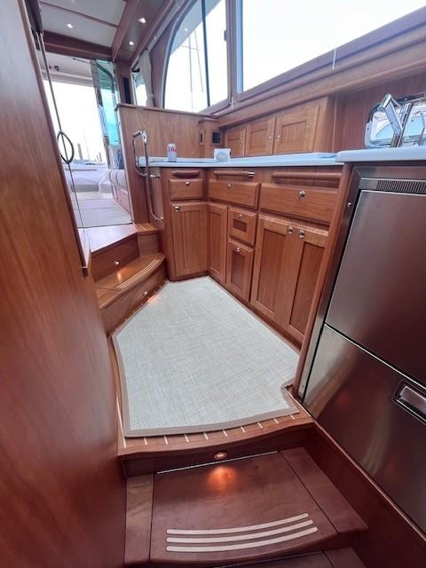 2021 Sabre 45 Salon Express interior with wooden cabinetry and modern kitchen appliances.