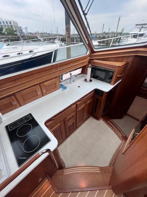 2021 Sabre 45 Salon Express yacht kitchen with wood cabinetry and modern appliances.