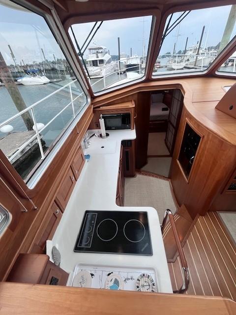 Interior of 2021 Sabre 45 Salon Express yacht with modern kitchen and marina view.