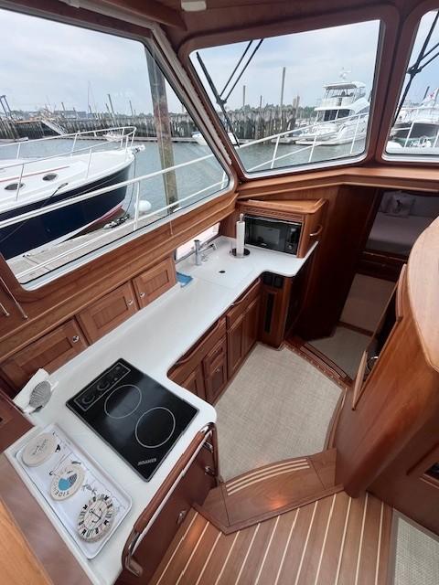 2021 Sabre 45 Salon Express yacht interior with wooden cabinetry and modern kitchen appliances.