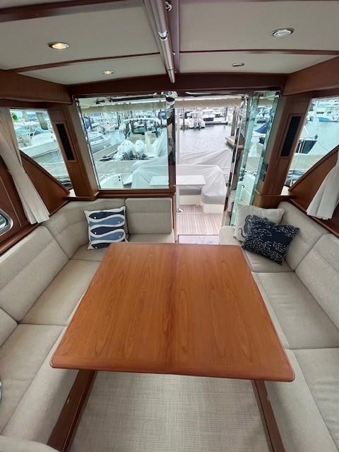 2021 Sabre 45 Salon Express interior with elegant wood table and plush seating.