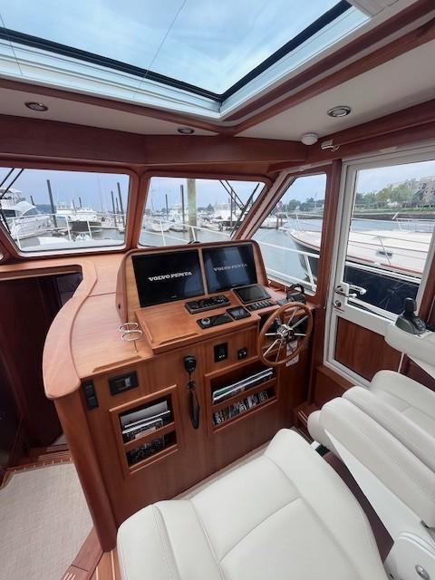 Interior of 2021 Sabre 45 Salon Express yacht with modern helm and panoramic windows.
