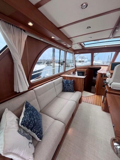 Interior of 2021 Sabre 45 Salon Express yacht with elegant wood finish and plush seating.