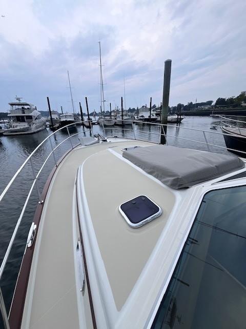 2021 Sabre 45 Salon Express yacht docked at marina, overcast sky.