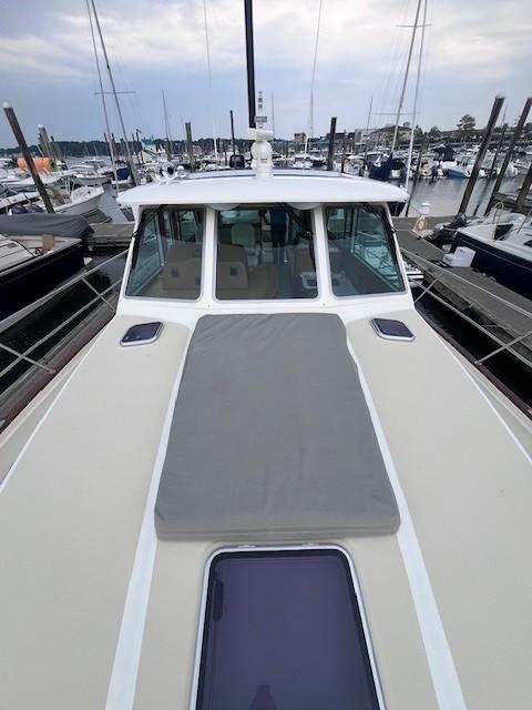 2021 Sabre 45 Salon Express yacht docked at marina, showcasing sleek design and spacious deck.