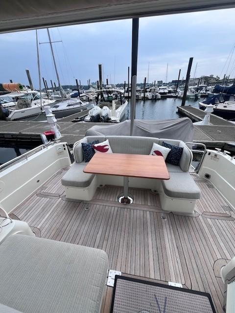 2021 Sabre 45 Salon Express yacht with elegant outdoor seating and marina view.