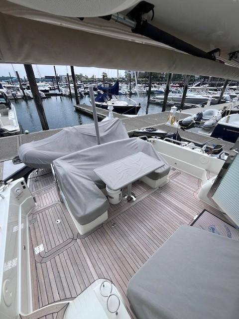 2021 Sabre 45 Salon Express yacht deck with covered seating at marina.