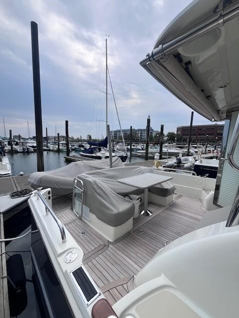 2021 Sabre 45 Salon Express yacht docked at marina, featuring covered seating area.