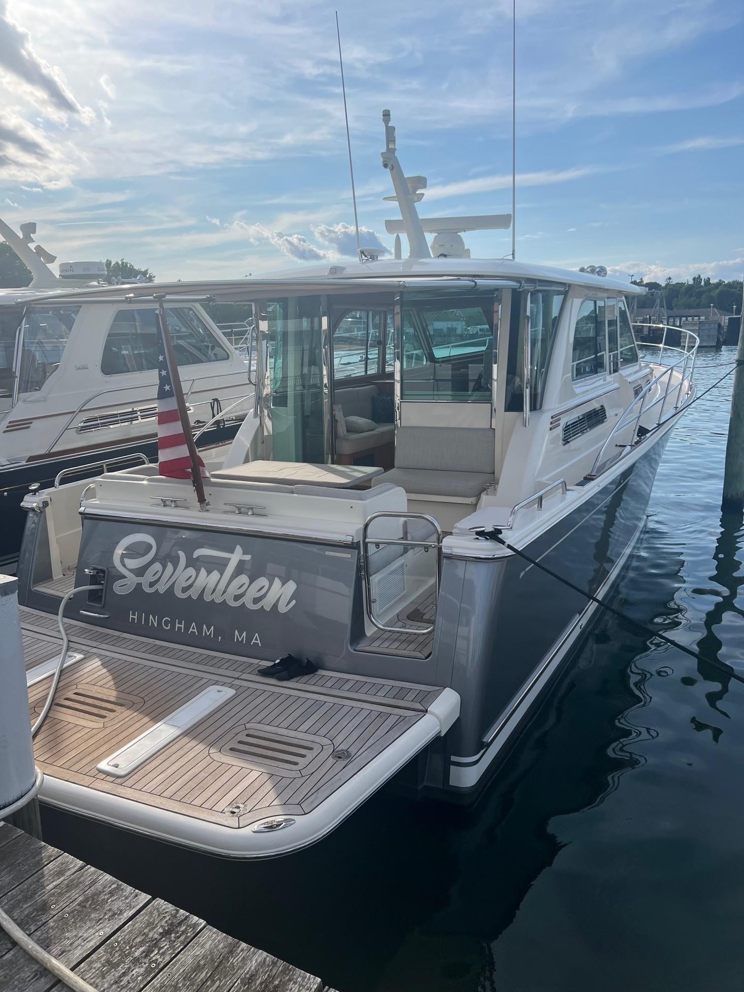 2021 Sabre 45 Salon Express yacht docked, named u0022Seventeen,u0022 with American flag, Hingham, MA.