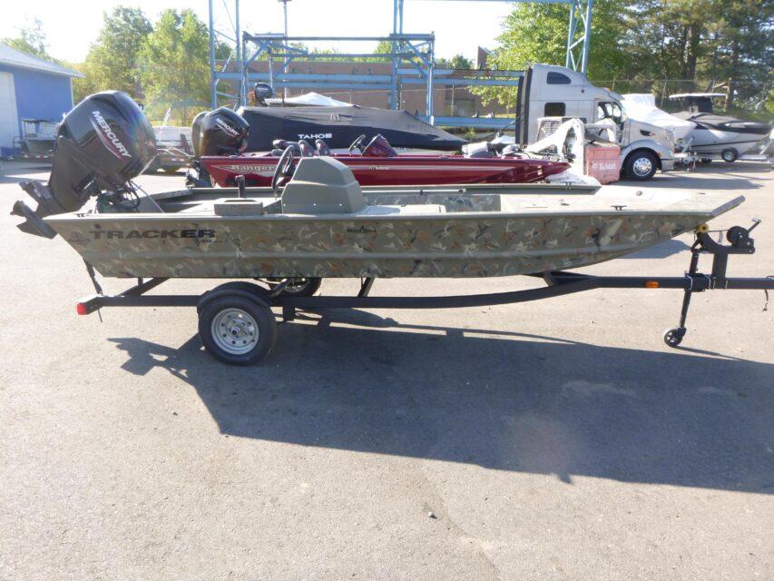 2024 Tracker Grizzly 1648 SC boat on trailer in outdoor setting.
