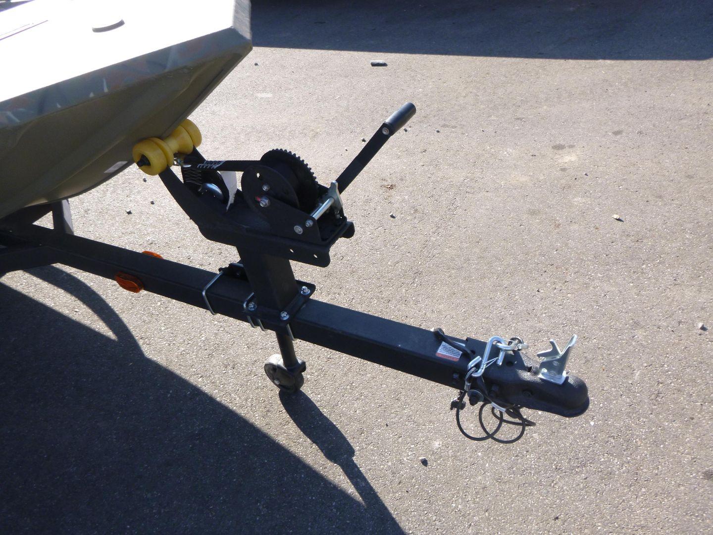 2024 Tracker Grizzly 1648 SC trailer hitch and winch on pavement.