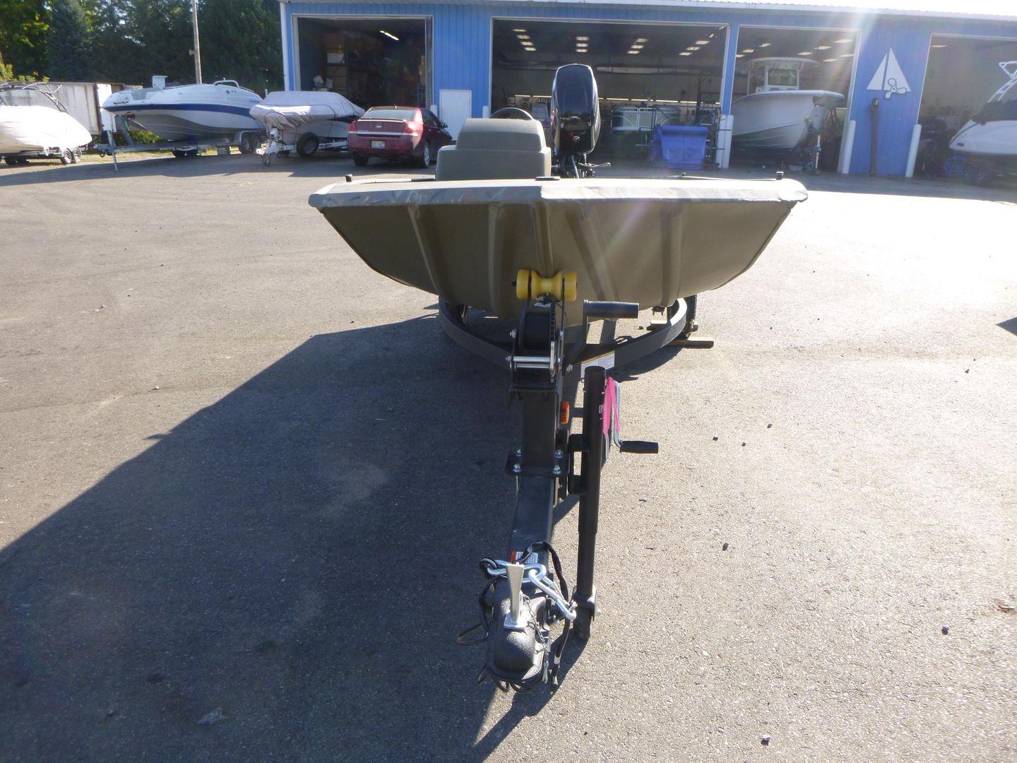 2024 Tracker Grizzly 1648 SC boat on trailer in outdoor showroom.