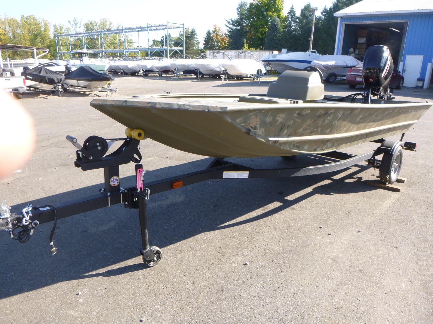 2024 Tracker Grizzly 1648 SC boat on trailer in outdoor lot.