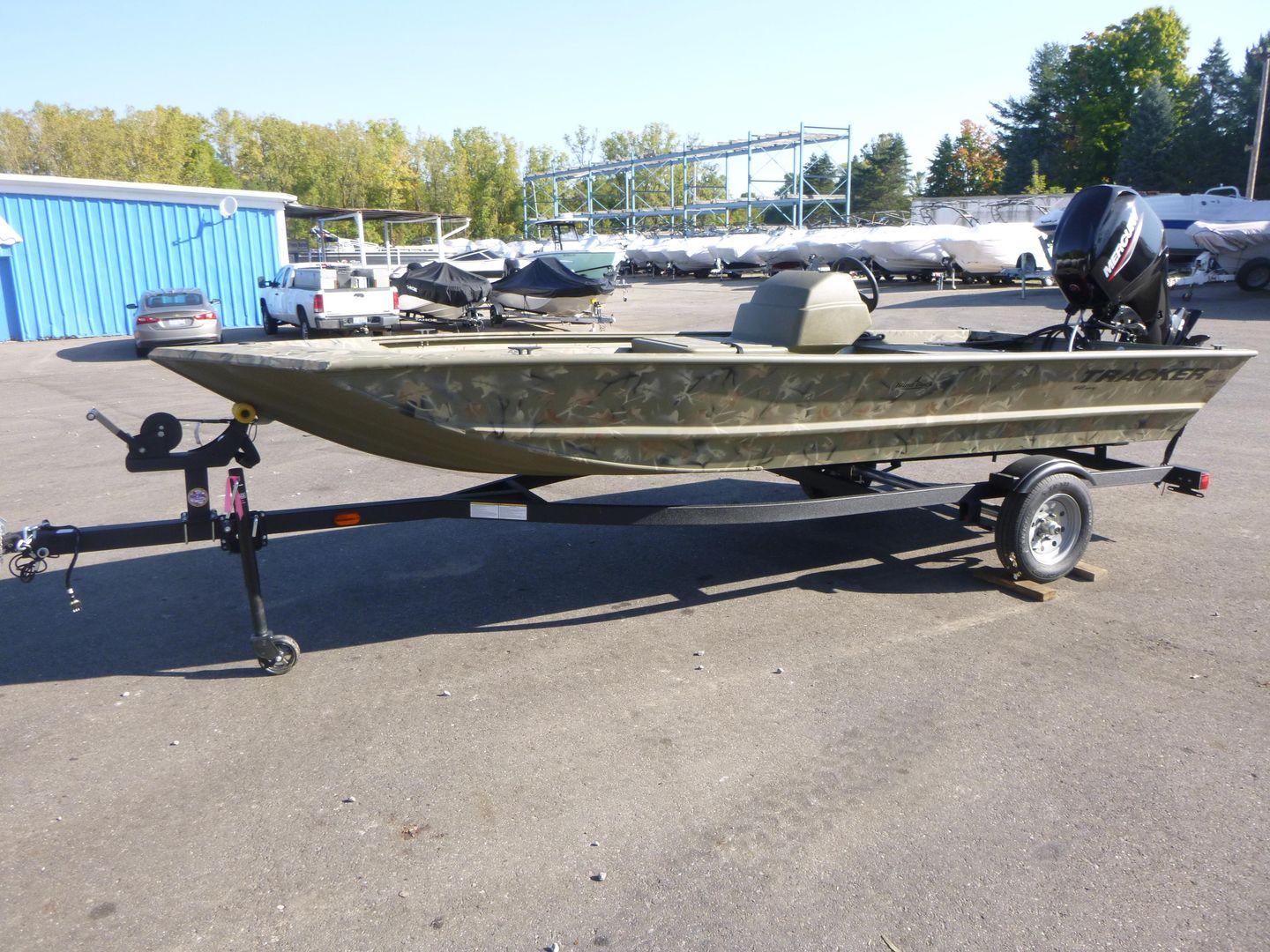 2024 Tracker Grizzly 1648 SC boat on trailer in outdoor lot.