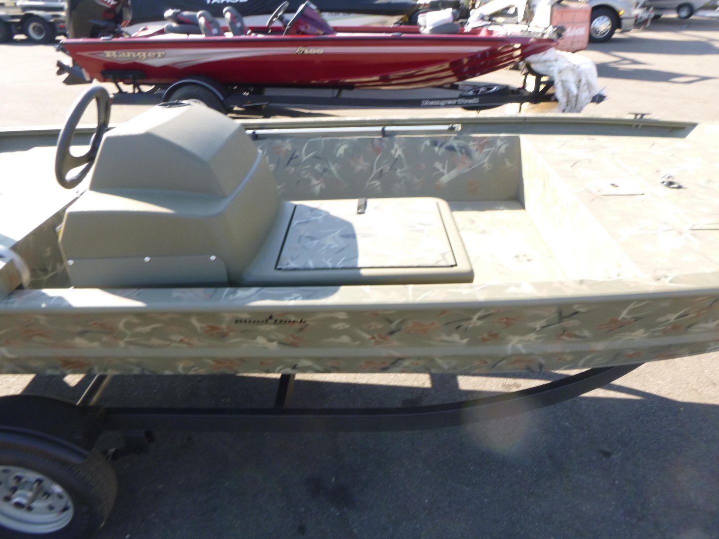 2024 Tracker Grizzly 1648 SC boat with camouflage design on a trailer.