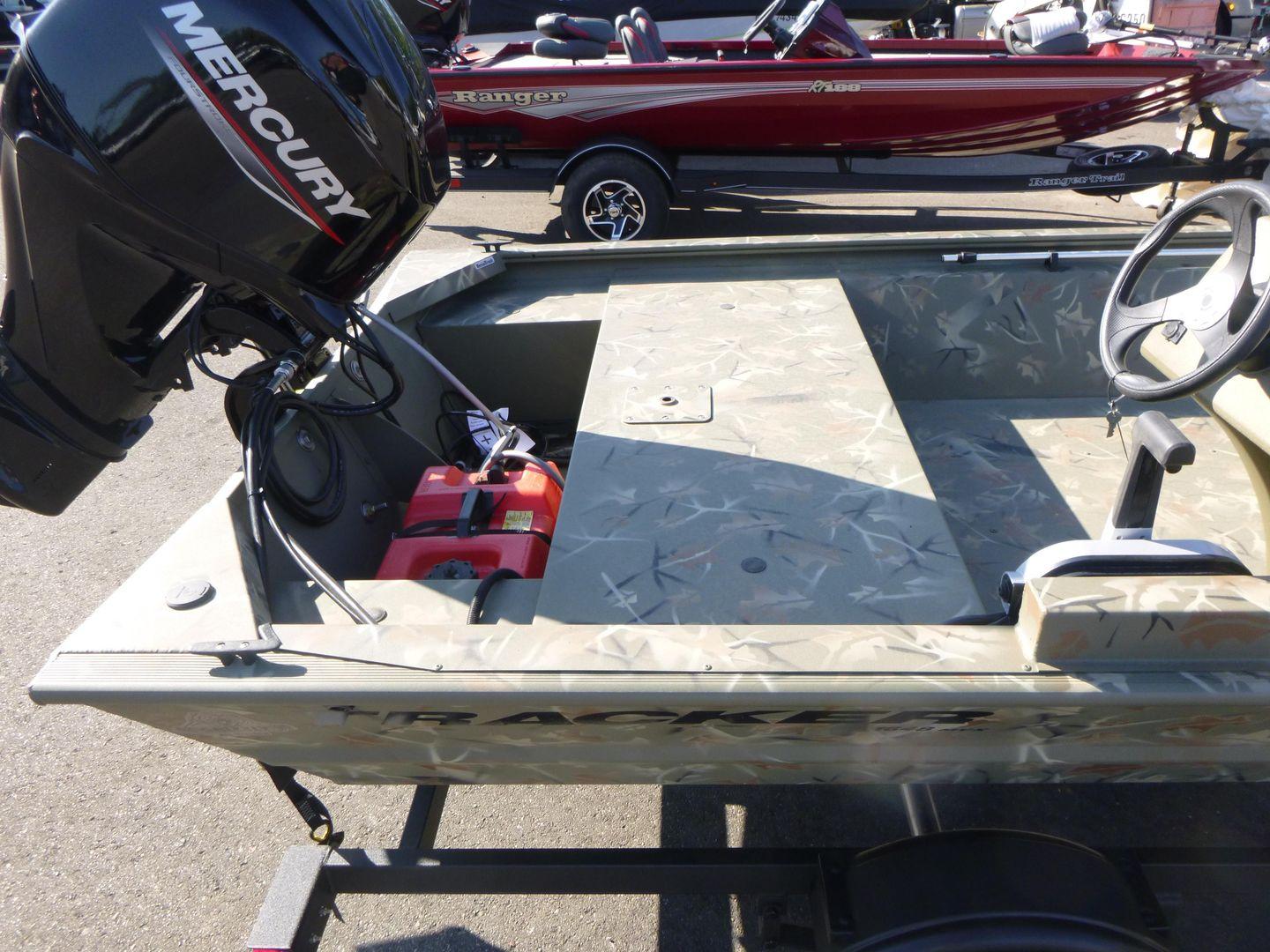 2024 Tracker Grizzly 1648 SC boat with Mercury outboard motor, parked on a trailer.