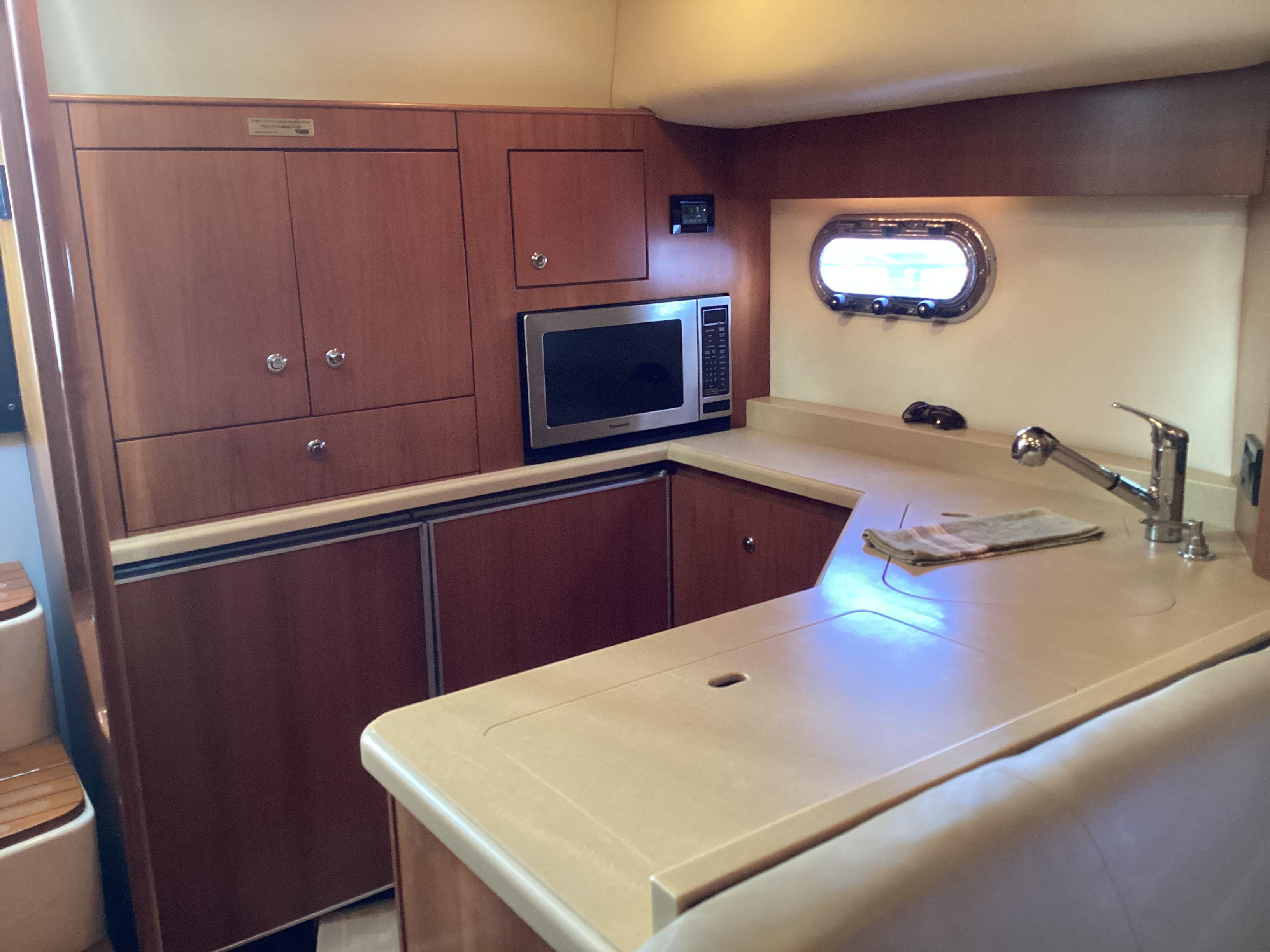 Tiara Yachts-4400 Sovran 2004-CC Rider FL-US-2004 Tiara Yachts 4400 Sovran kitchen with wood cabinetry and modern appliances.-9631623 | Thumbnail