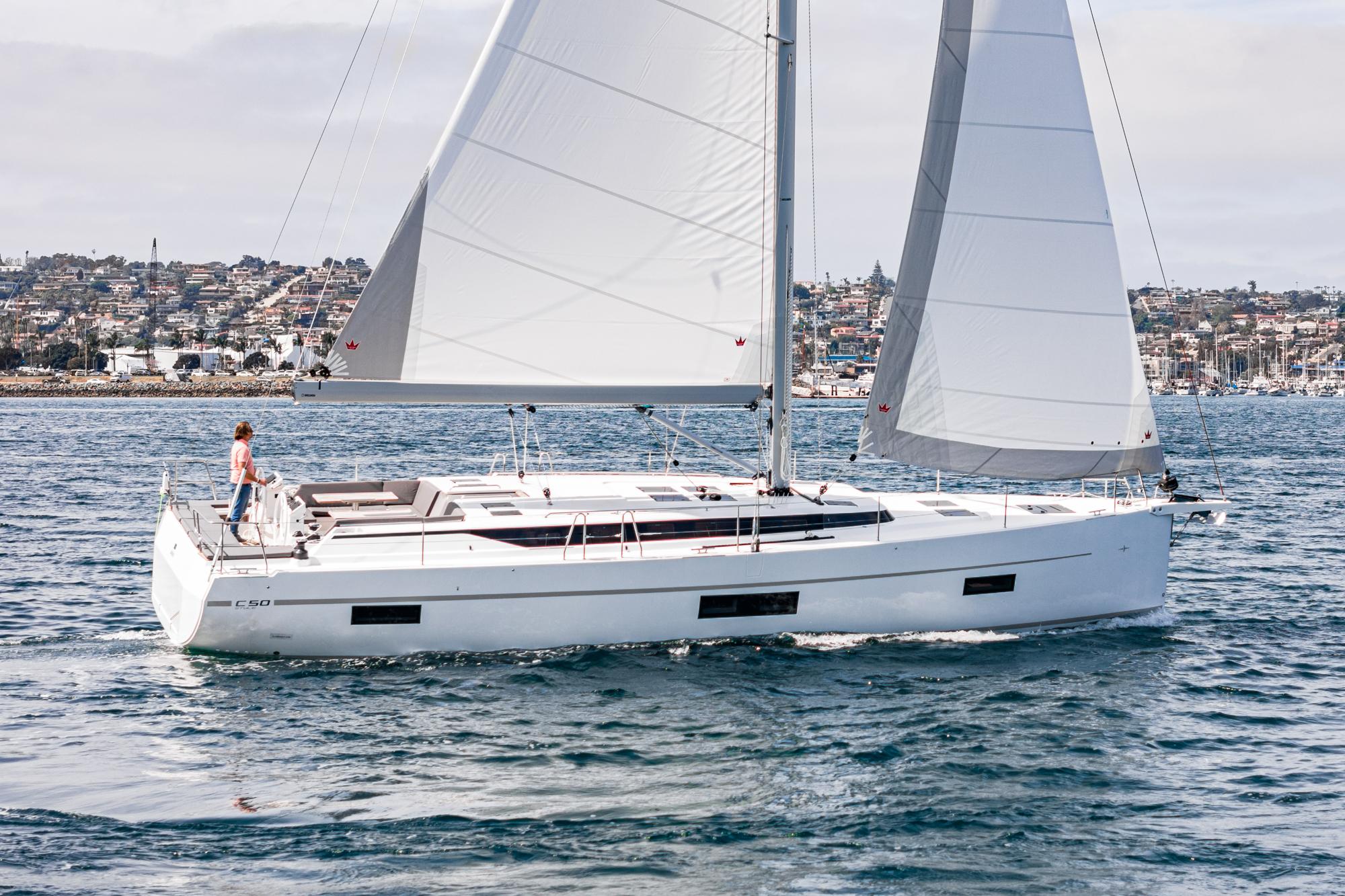 Bavaria-C50 2024-This could be yours CA-US-2024 Bavaria C50 sailboat cruising on open water near a coastal city.-9654457 | Thumbnail