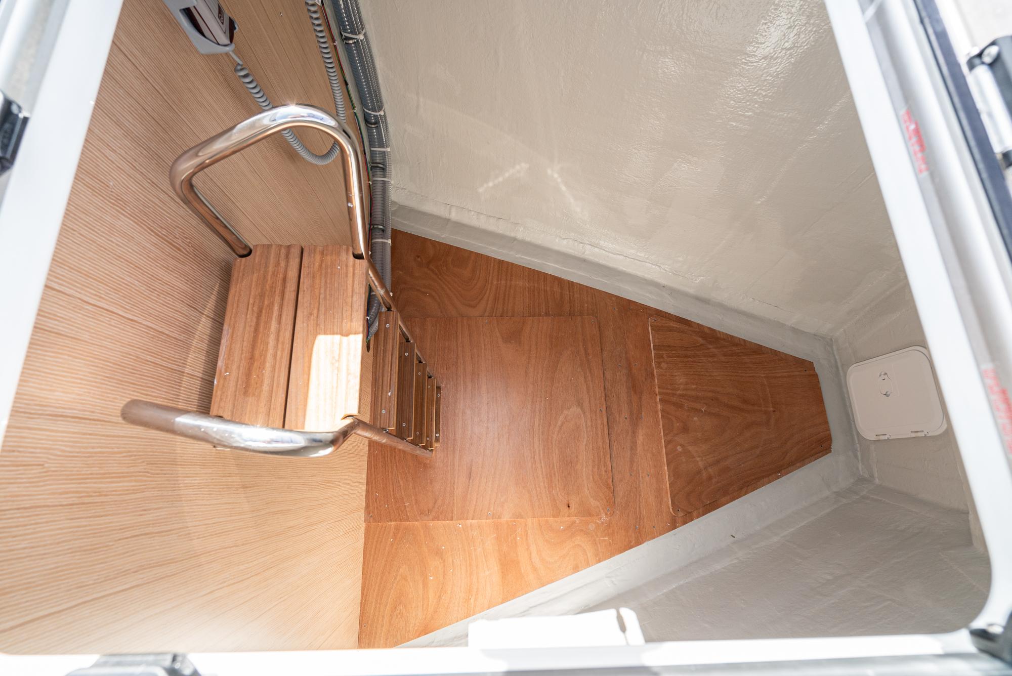 Bavaria-C50 2024-This could be yours CA-US-Interior view of 2024 Bavaria C50 sailboat with wooden flooring and metal ladder.-9654457 | Thumbnail