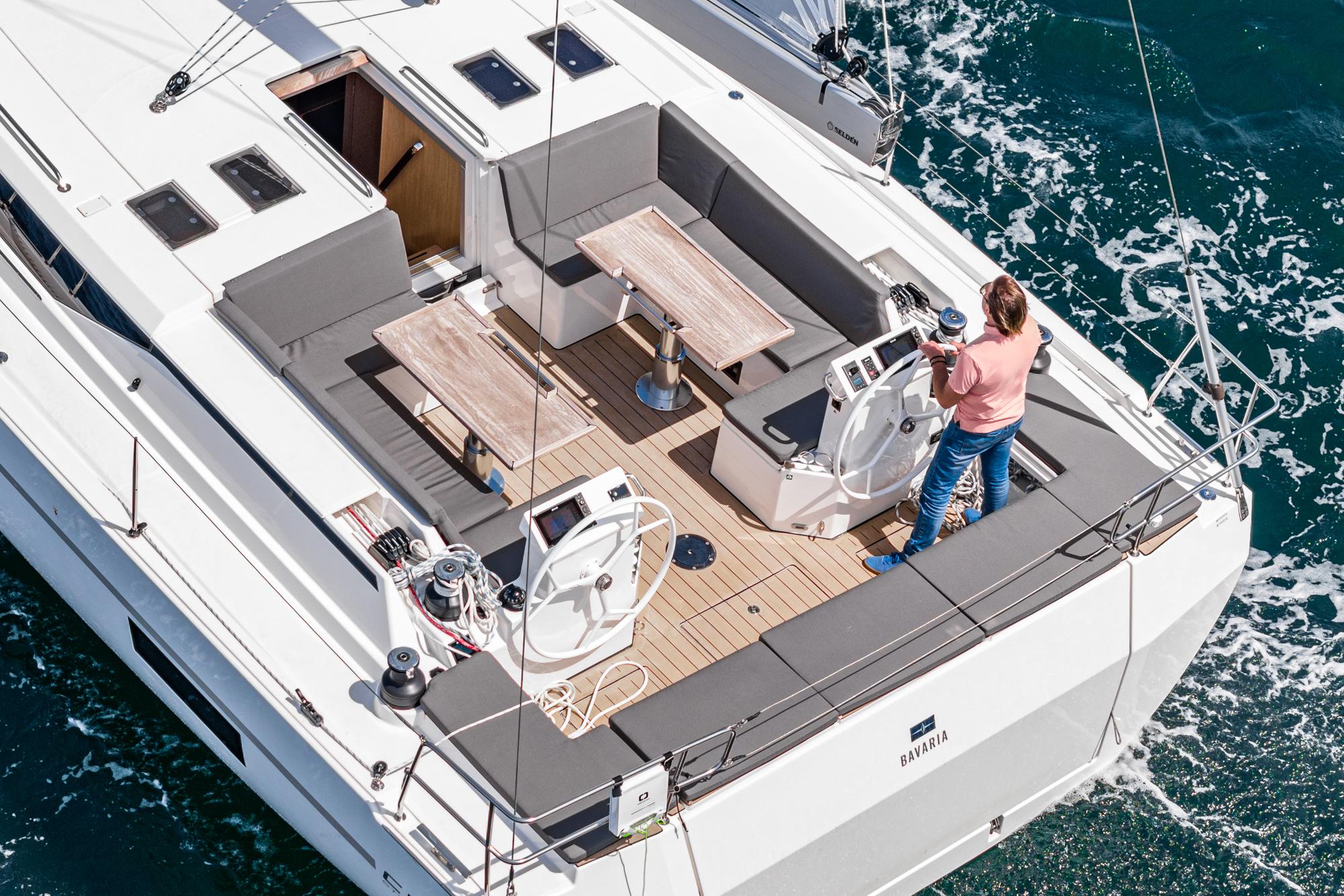 Bavaria-C50 2024-This could be yours CA-US-2024 Bavaria C50 yacht sailing with person at helm, featuring spacious deck and seating area.-9654457 | Thumbnail