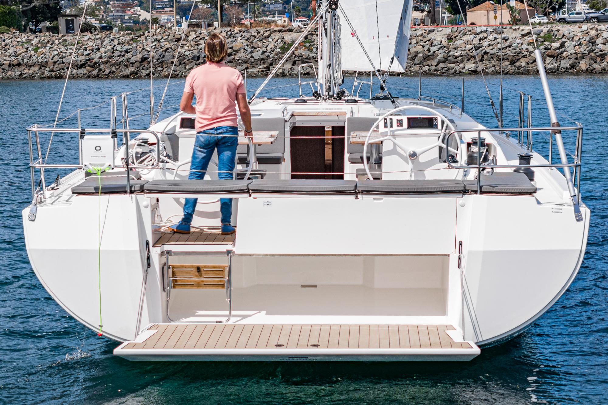 Bavaria-C50 2024-This could be yours CA-US-2024 Bavaria C50 yacht with person on deck, sailing in calm waters.-9654457 | Thumbnail