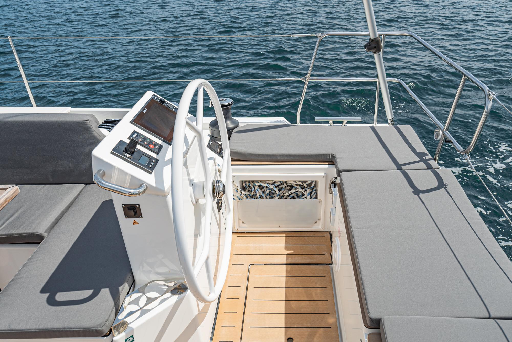 Bavaria-C50 2024-This could be yours CA-US-2024 Bavaria C50 yacht helm with modern controls and comfortable seating on open water.-9654457 | Thumbnail