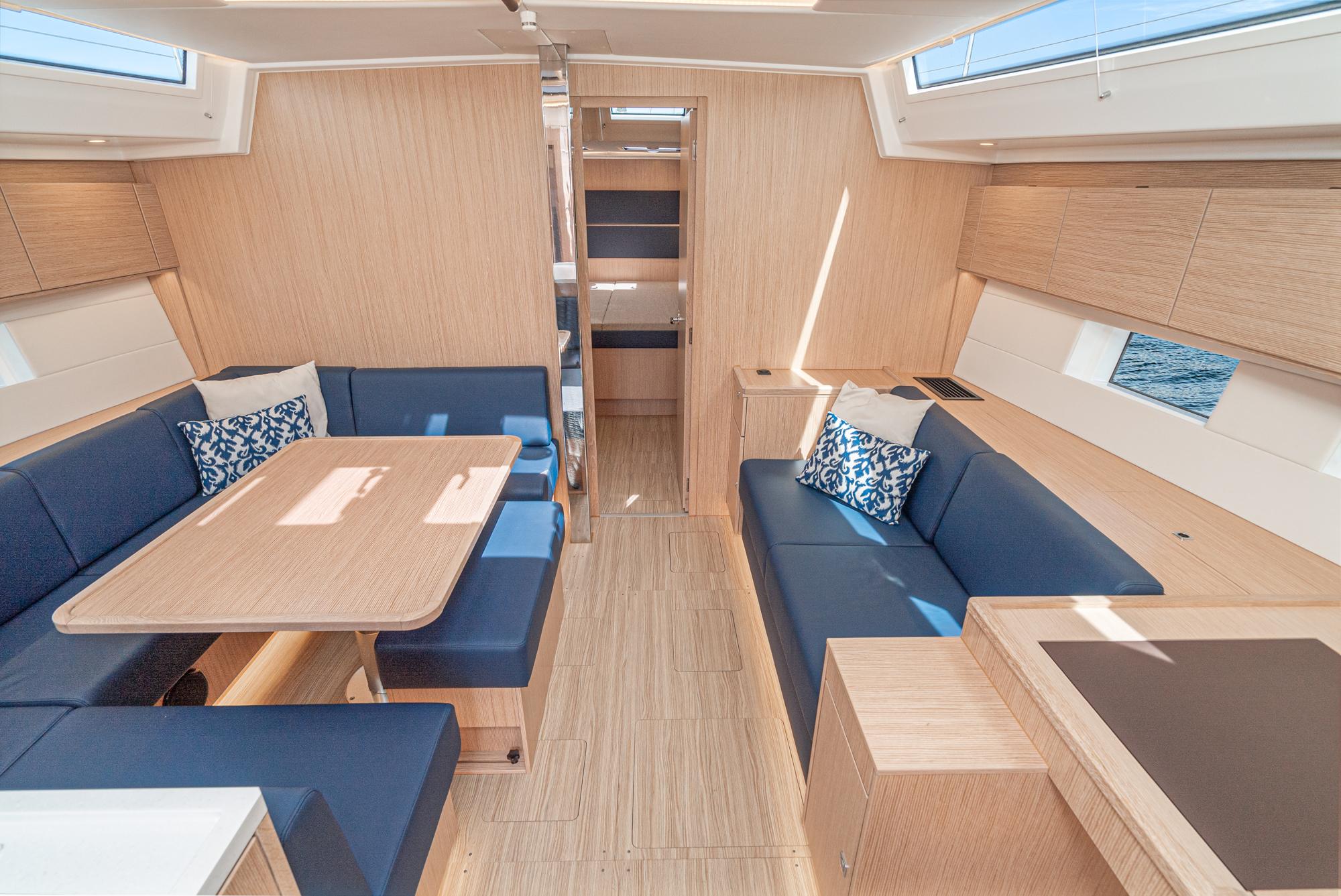 Bavaria-C50 2024-This could be yours CA-US-2024 Bavaria C50 yacht interior with modern wood finish and blue seating.-9654457 | Thumbnail