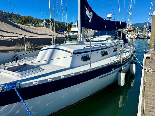 1996 Valiant 39 sailboat docked in marina, featuring sleek design and blue accents.