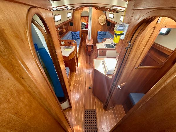 Interior of 1996 Valiant 39 sailboat with wooden finish and cozy seating area.
