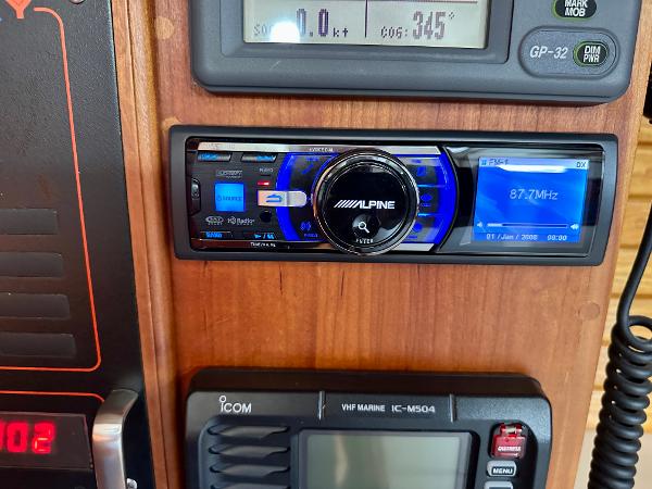 Alpine stereo system on a 1996 Valiant 39 boat dashboard with Icom VHF radio.