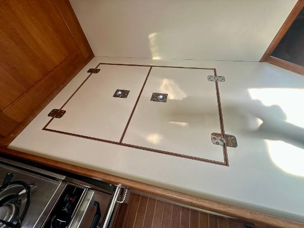 1996 Valiant 39 yacht interior with wooden cabinetry and stainless steel stove.