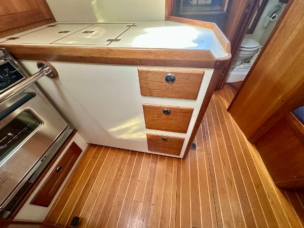 1996 Valiant 39 yacht interior with wooden cabinetry and flooring.
