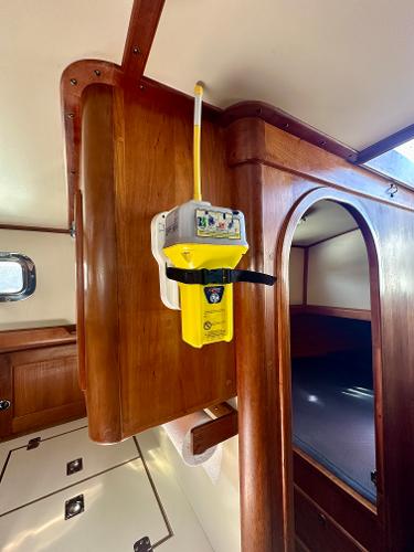 1996 Valiant 39 interior with mounted emergency beacon, wooden cabinetry, and cozy sleeping area.